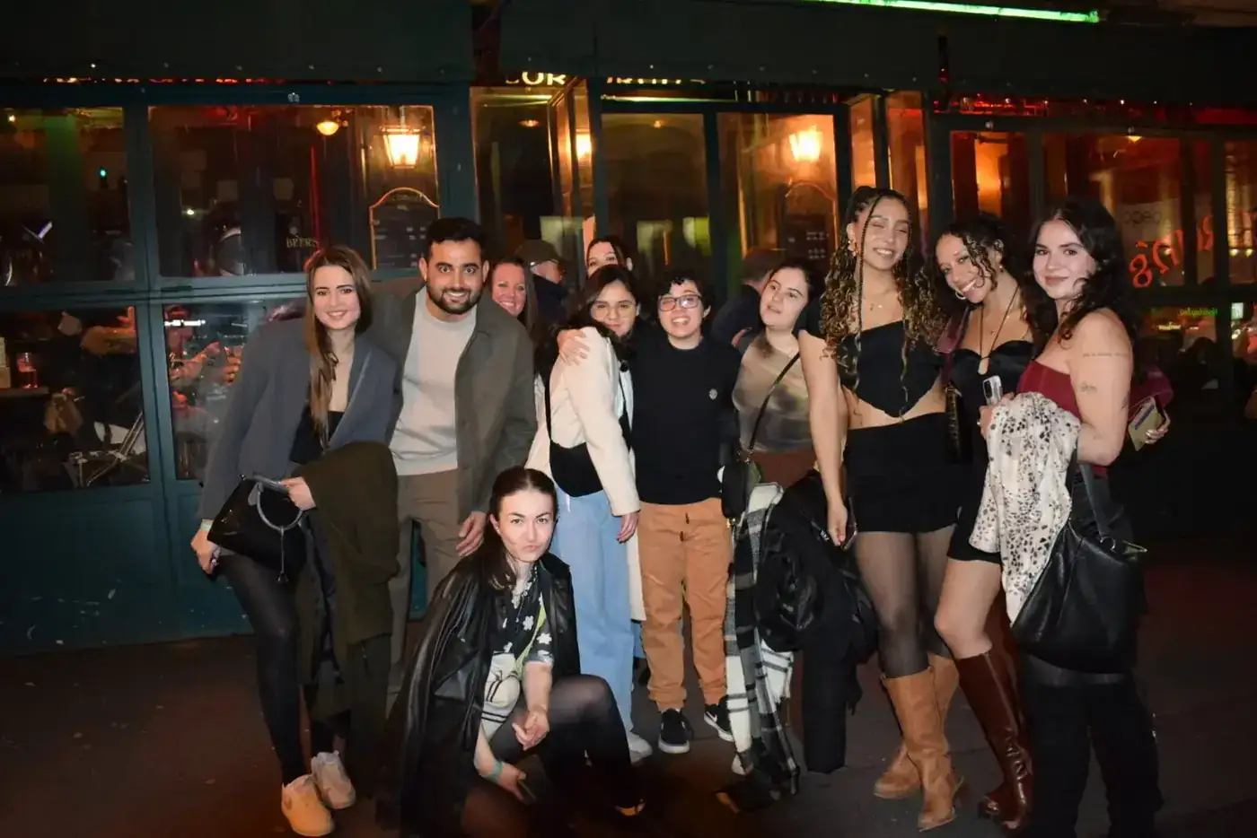 Guests enjoying the Paris pub crawl at night